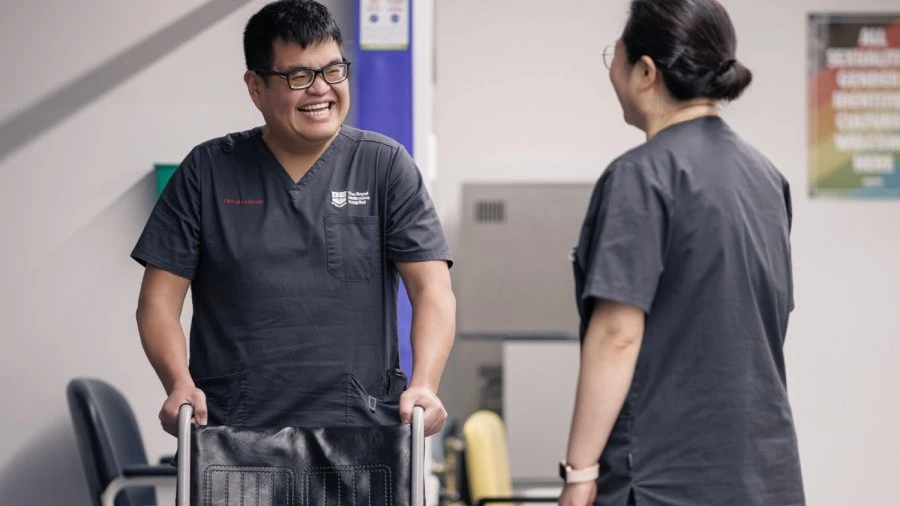 clinical-assistants-smiling-with-empty-wheelchair.jpg