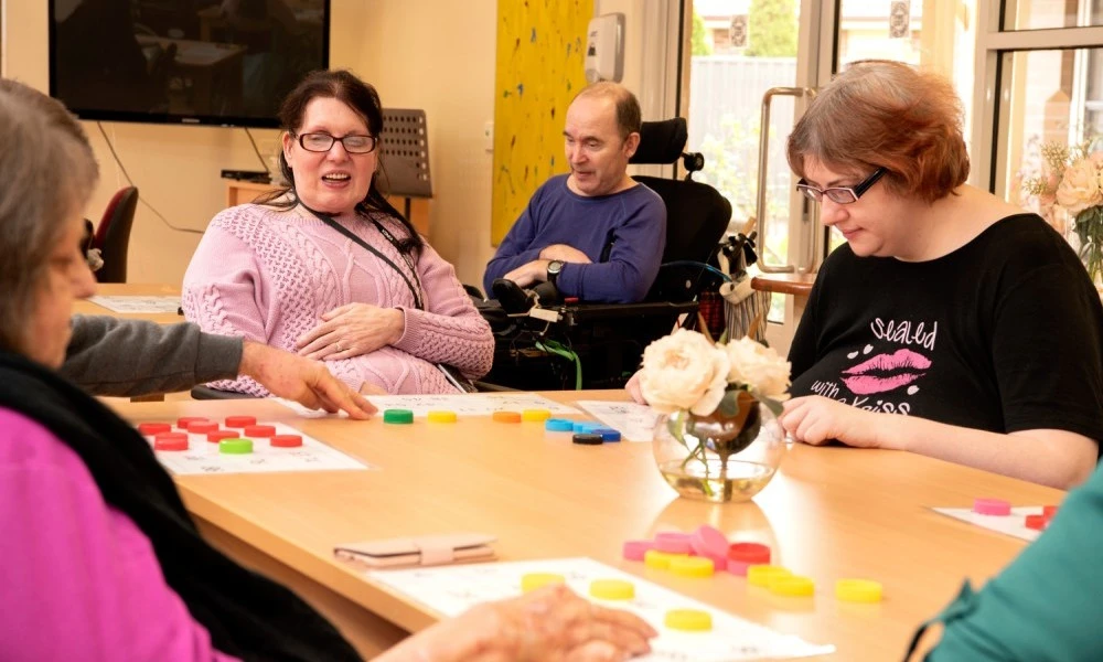 Residents playing tabletop game at Cyril Jewell House